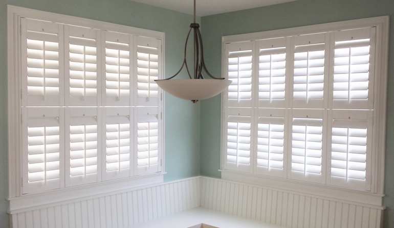 Pastel green wall in Charlotte kitchen with shutters.